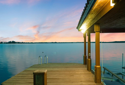 dock overlooking a body of water at sunset